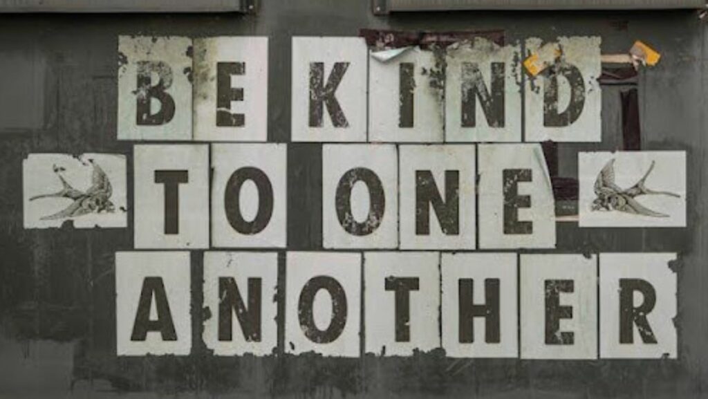 “Be kind to one another” written on a wall