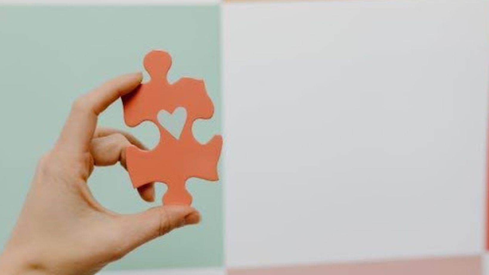 Hand holding a puzzle piece