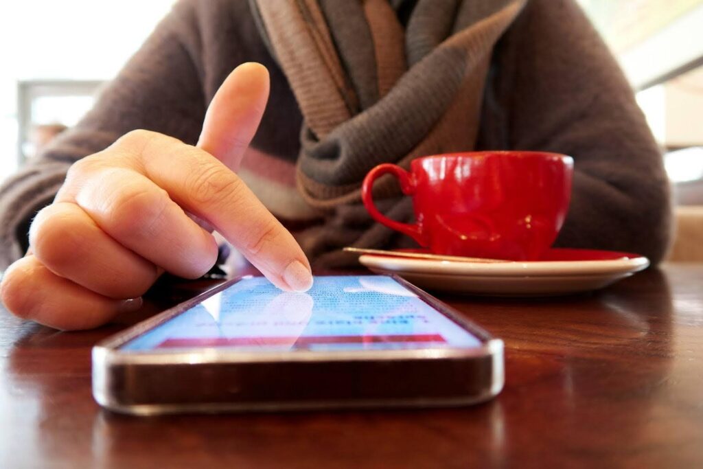 A person engaging in a so-called relaxation scroll while drinking coffee.